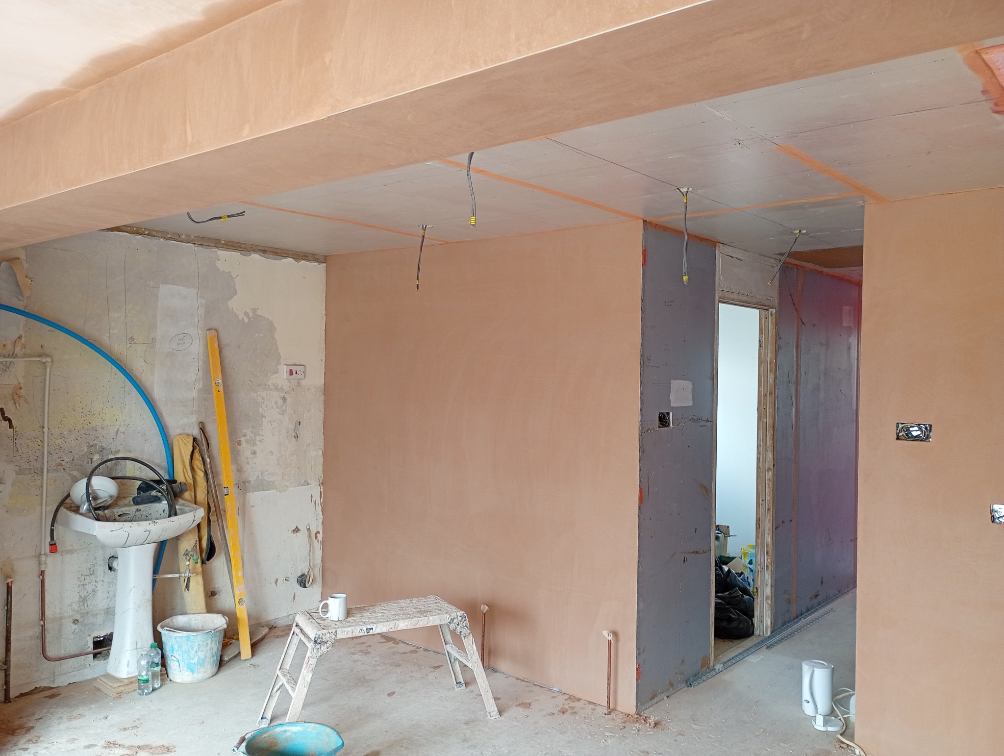 Walls and ceilings skimmed through the open plan kitchen and hallway in Whitstable